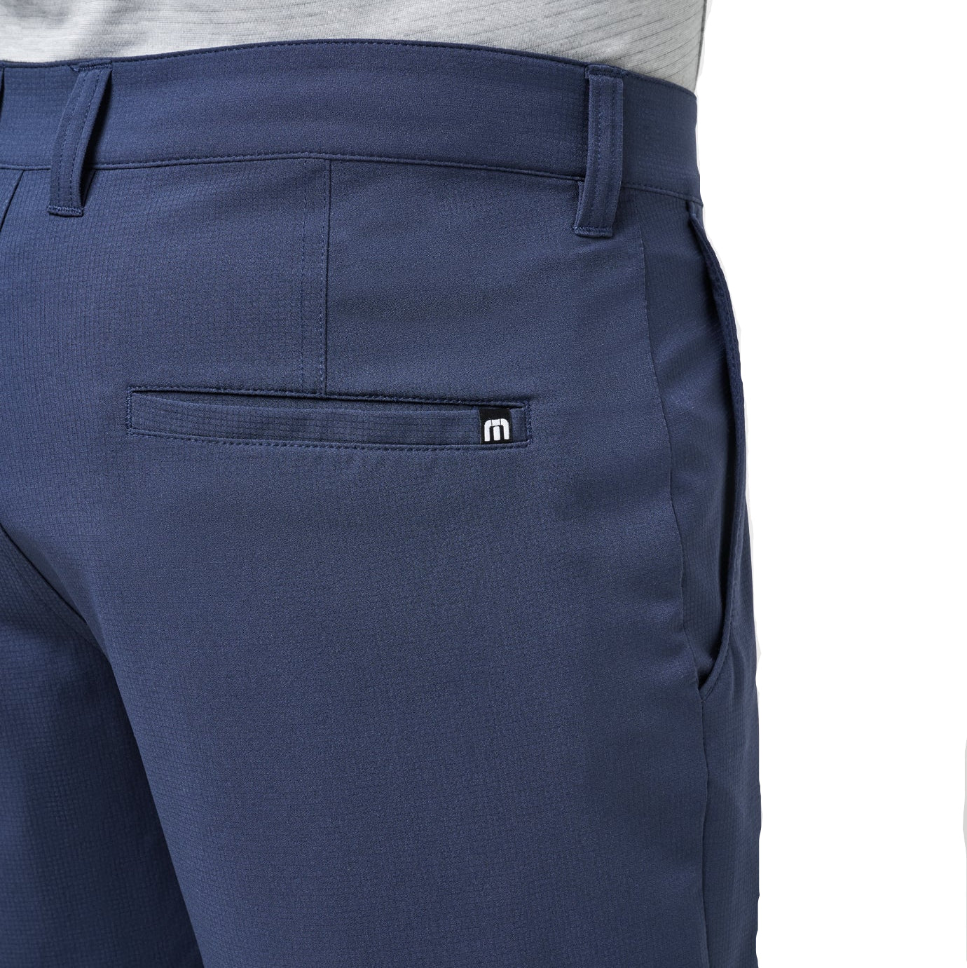 Navy blue pants with a brand logo on a white background