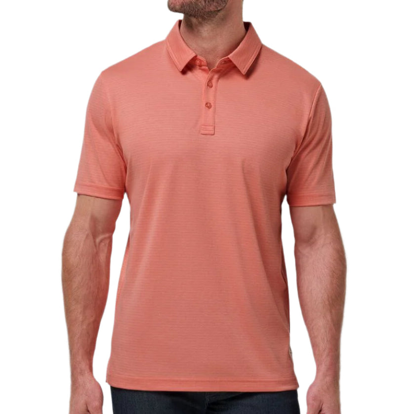 Man wearing a coral polo shirt against a plain background