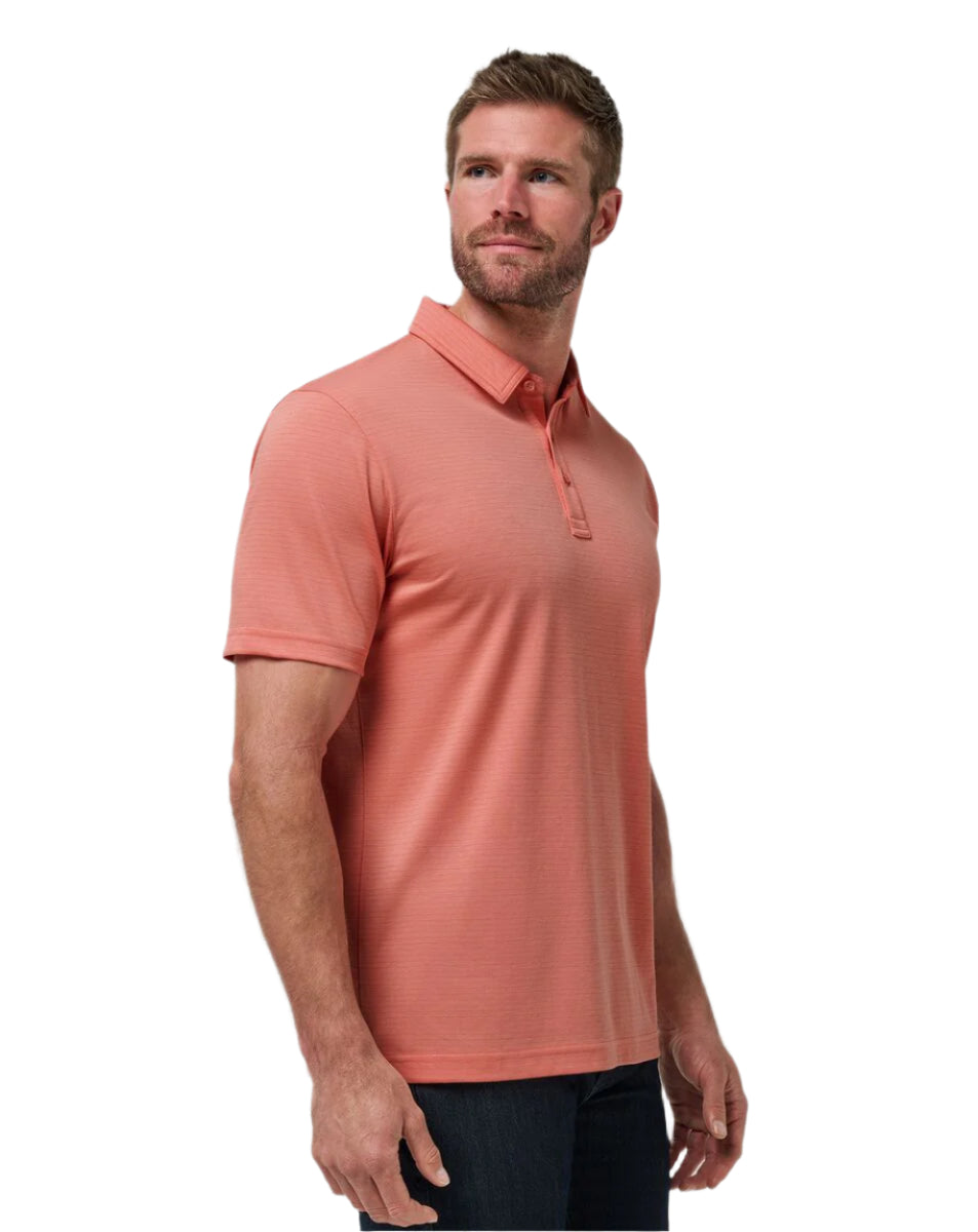 Man wearing a coral polo shirt on a white background