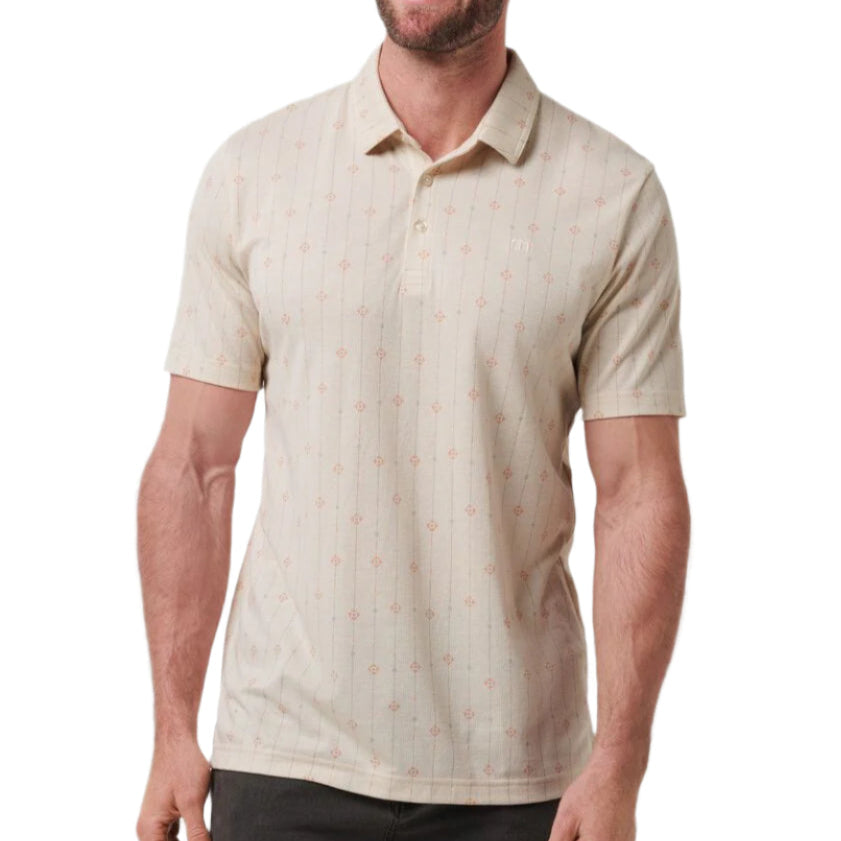 Man wearing a beige patterned polo shirt on a white background