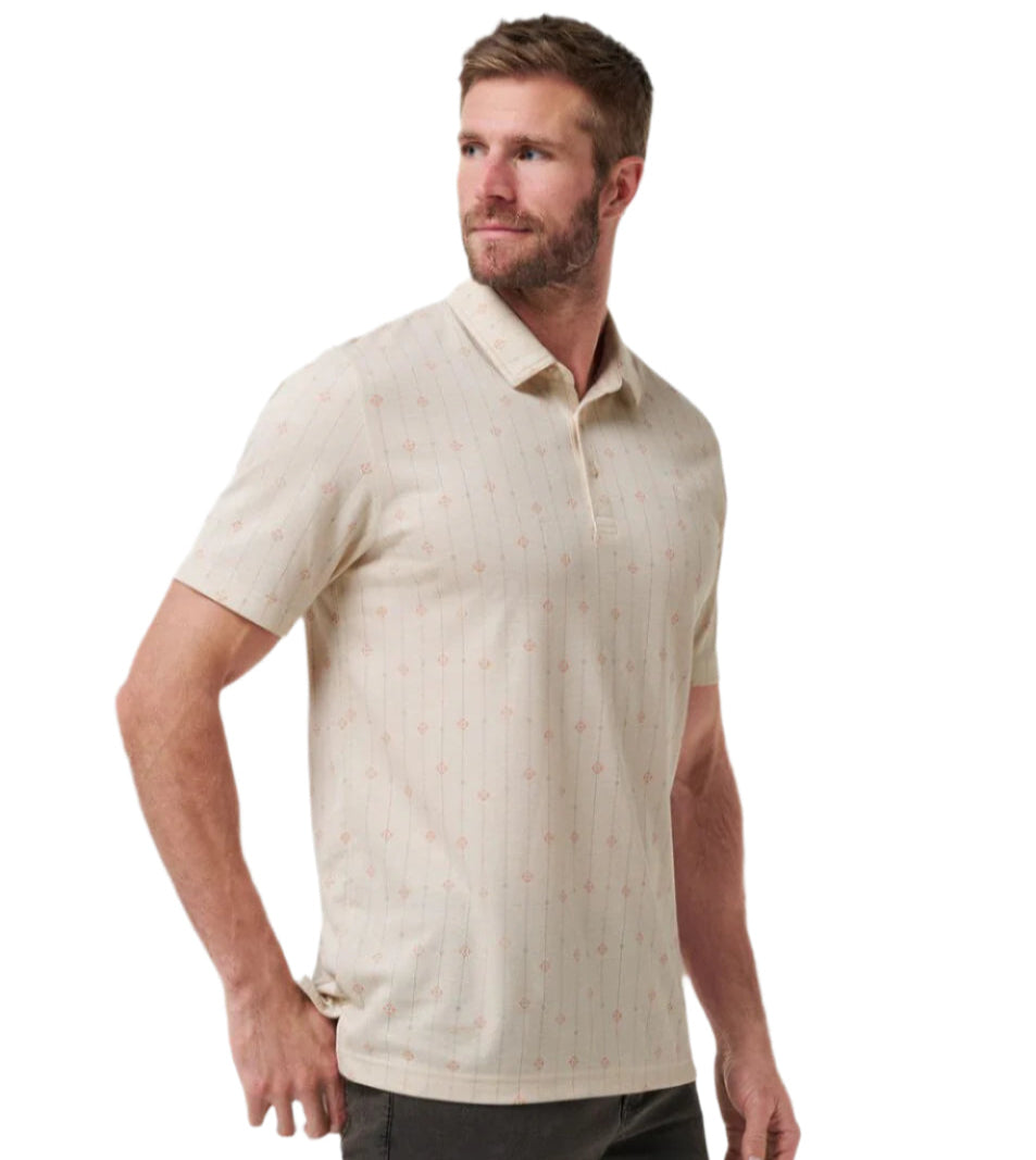 Man wearing a beige patterned polo shirt on a white background