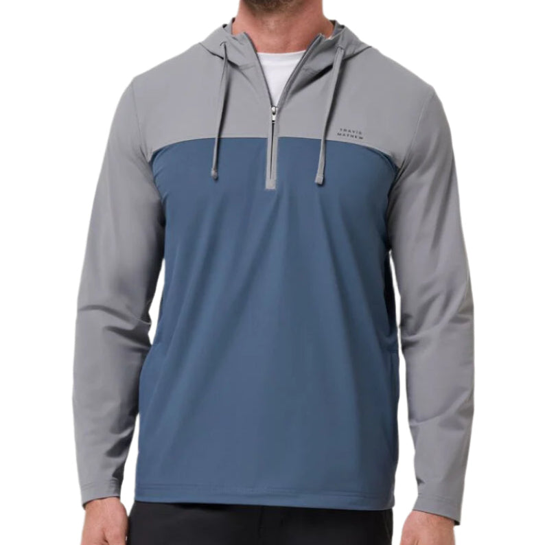 Man wearing a two-tone gray and blue hoodie on a white background