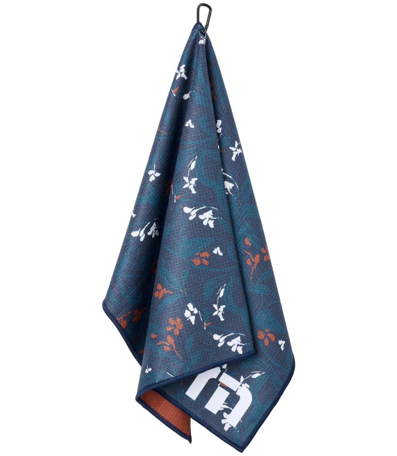 Blue towel with floral pattern hanging on a white background