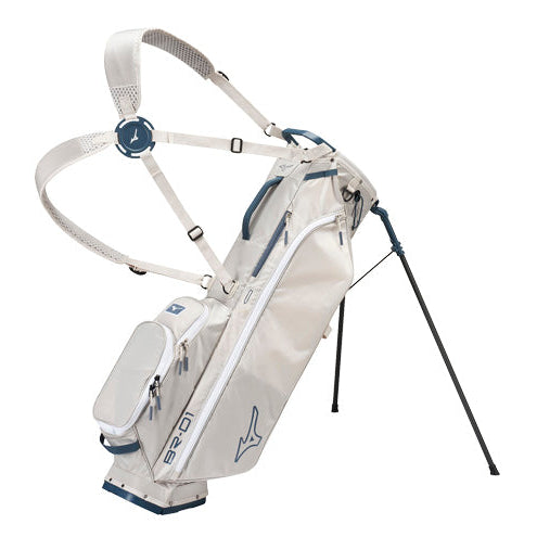 A Mizuno B20 golf stand bag in off-white with navy blue accents and white piping, shown with its shoulder straps extended and stand legs deployed against a solid white background.