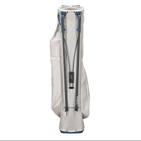 A light beige golf stand bag with dark gray and blue straps and trim, shown from the back against a solid white background.