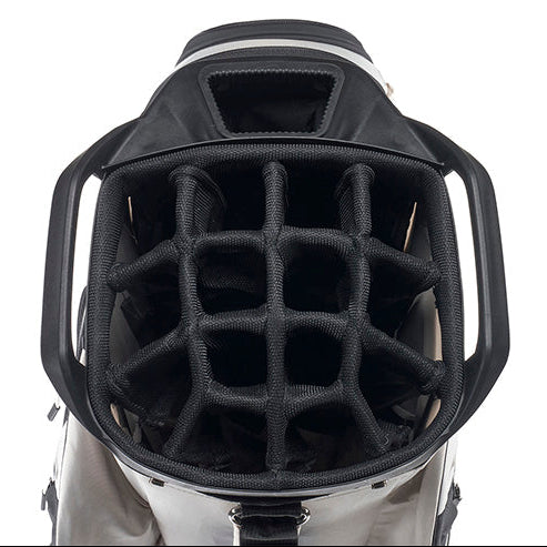 Close-up of the open top of a golf bag showing a black internal organizer grid and padded compartments, with a light gray exterior visible at the bottom on a white background.