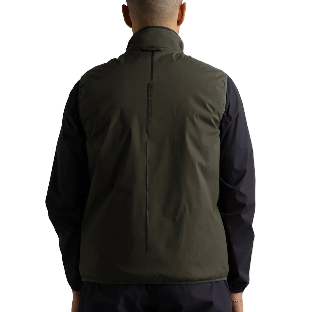 Person wearing a green and black jacket on a white background