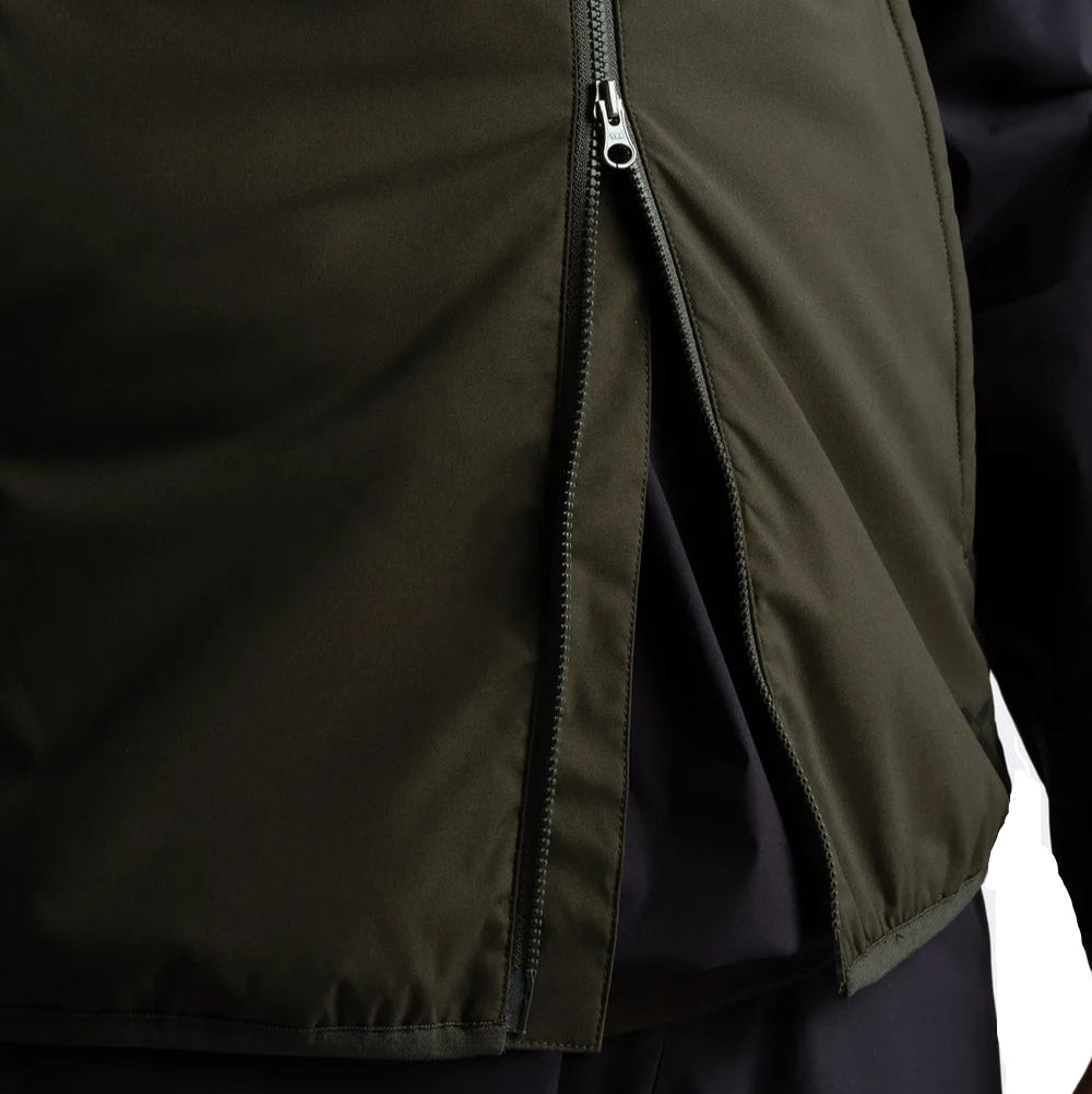 Close-up of a dark green jacket with a zipper on a black background