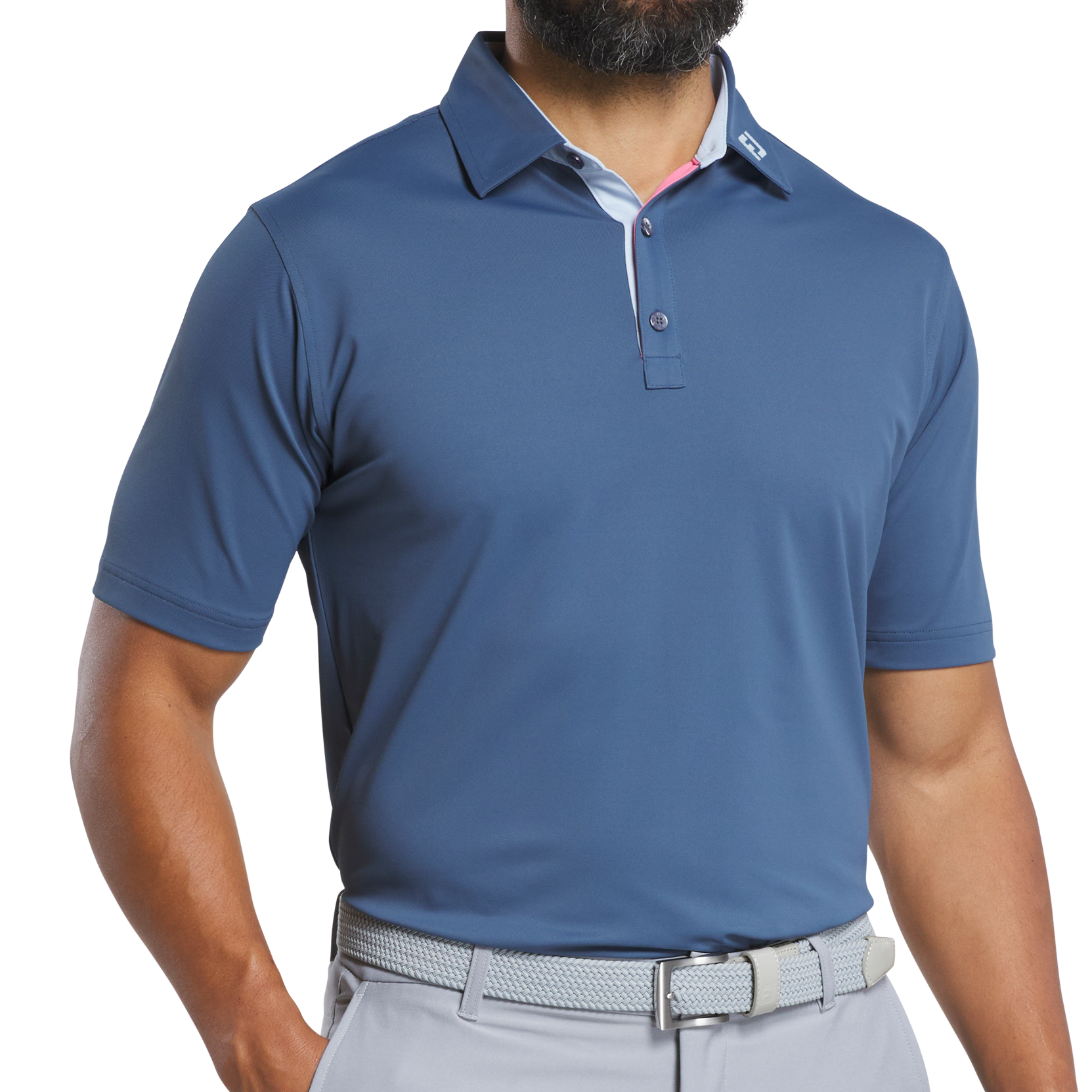 Man wearing a blue polo shirt and gray pants on a white background