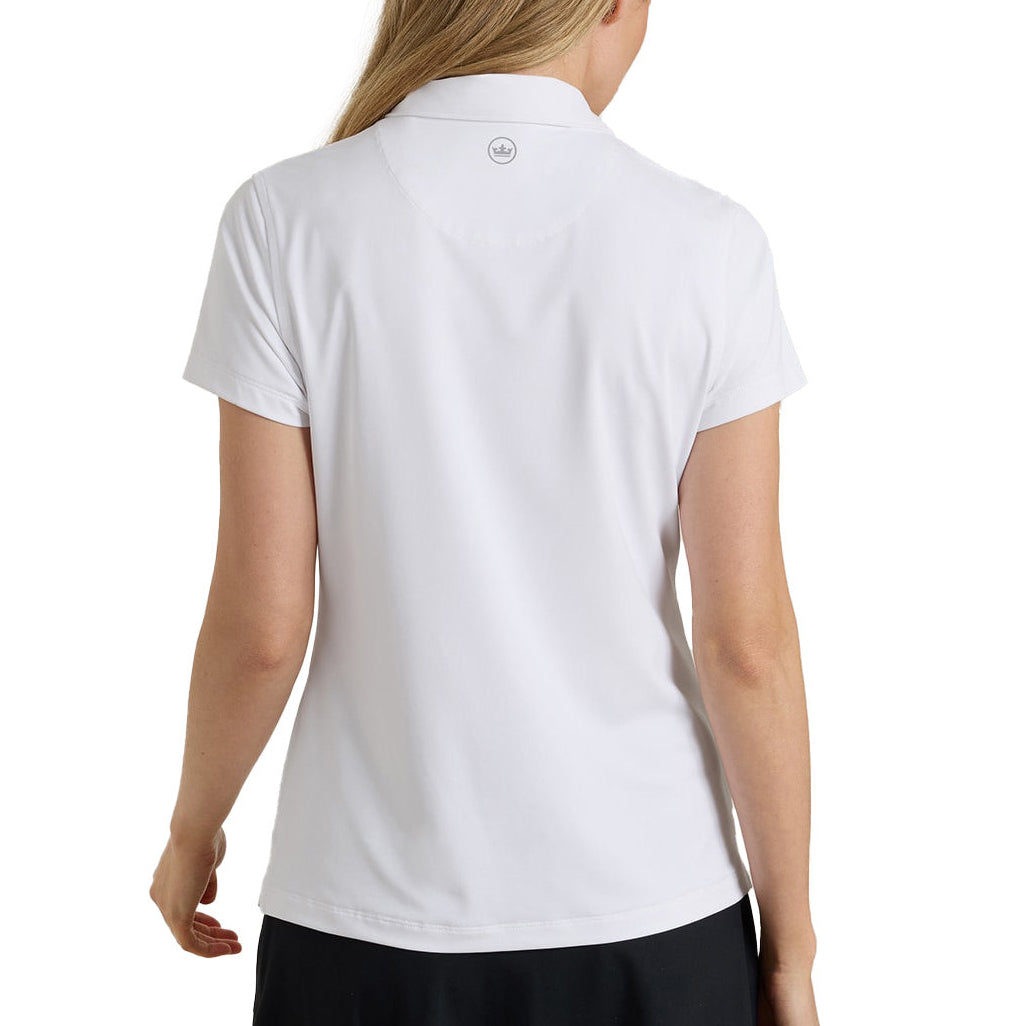 A woman shown from the back wearing a white short-sleeve polo shirt and a black skirt against a plain white studio background.