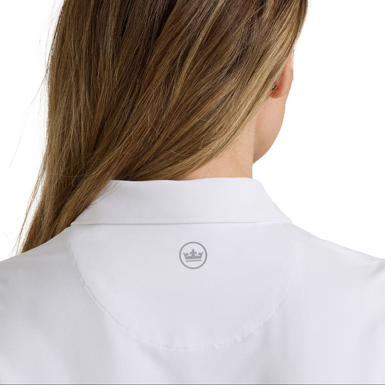 Back view of a woman with long brown hair wearing a white collared shirt, showing a small gray crown logo on the back of the collar.