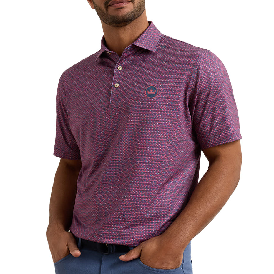 A man wearing a short-sleeve polo shirt in a dusty purple color with a subtle micro-pattern, paired with blue pants, against a solid white background.