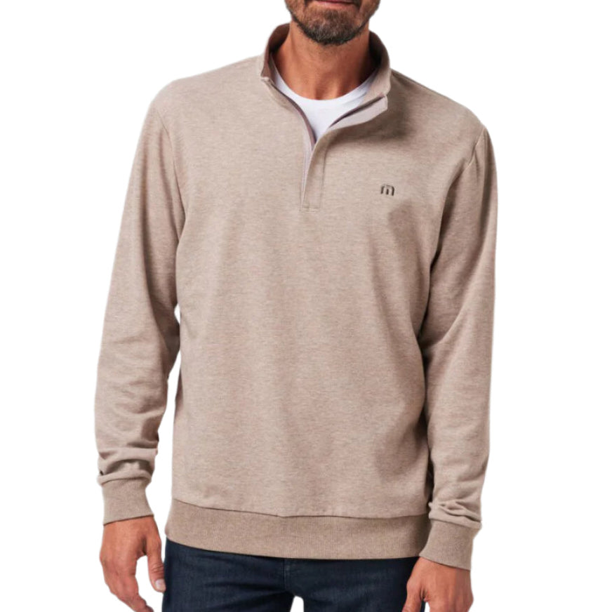 A man wearing a gray TravisMathew quarter zip fleece pullover.