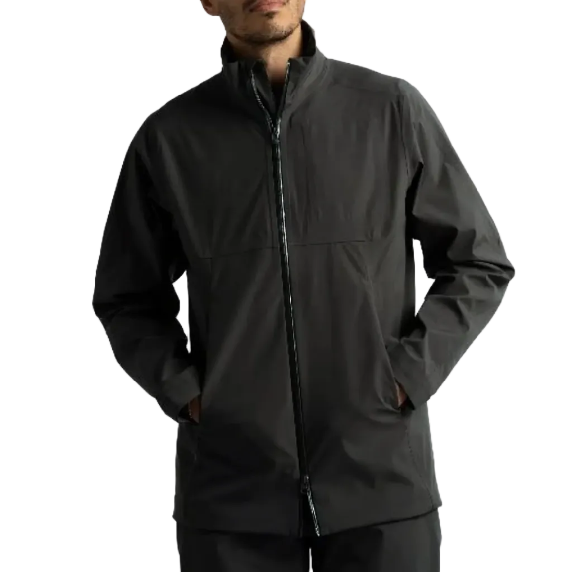 A man wearing a dark gray zip-up jacket with a stand-up collar