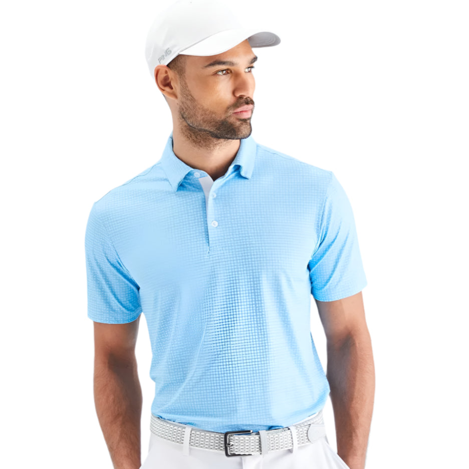 Man wearing a light blue polo shirt and white cap against a light gray background