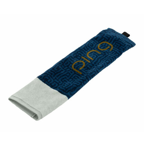 A Ping branded tri-fold towel in navy and gold colors, designed for use as a golf bag accessory.