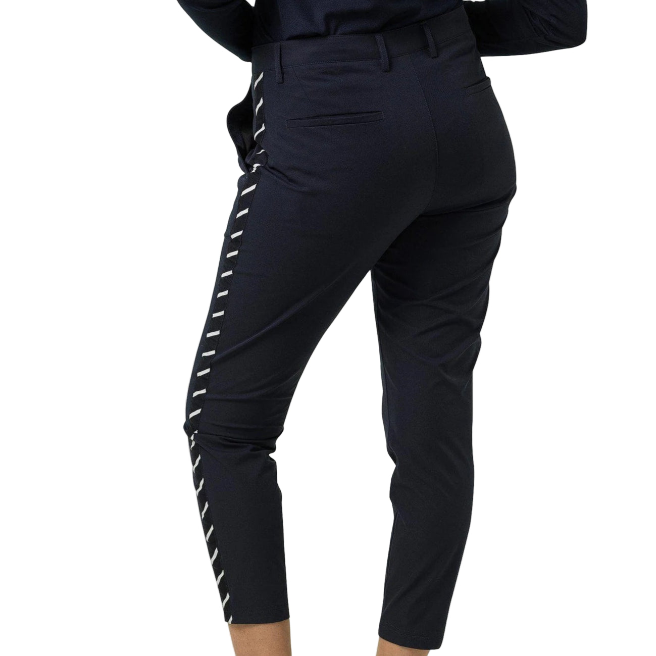 Person wearing black pants with white stripes and white sneakers on a white background