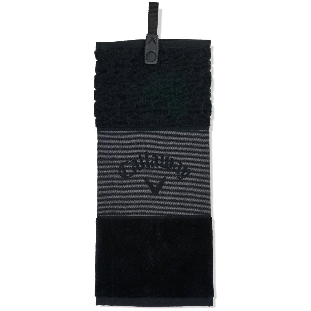 A black and gray Callaway tri-fold golf towel with a logo in the center and a snap attachment.