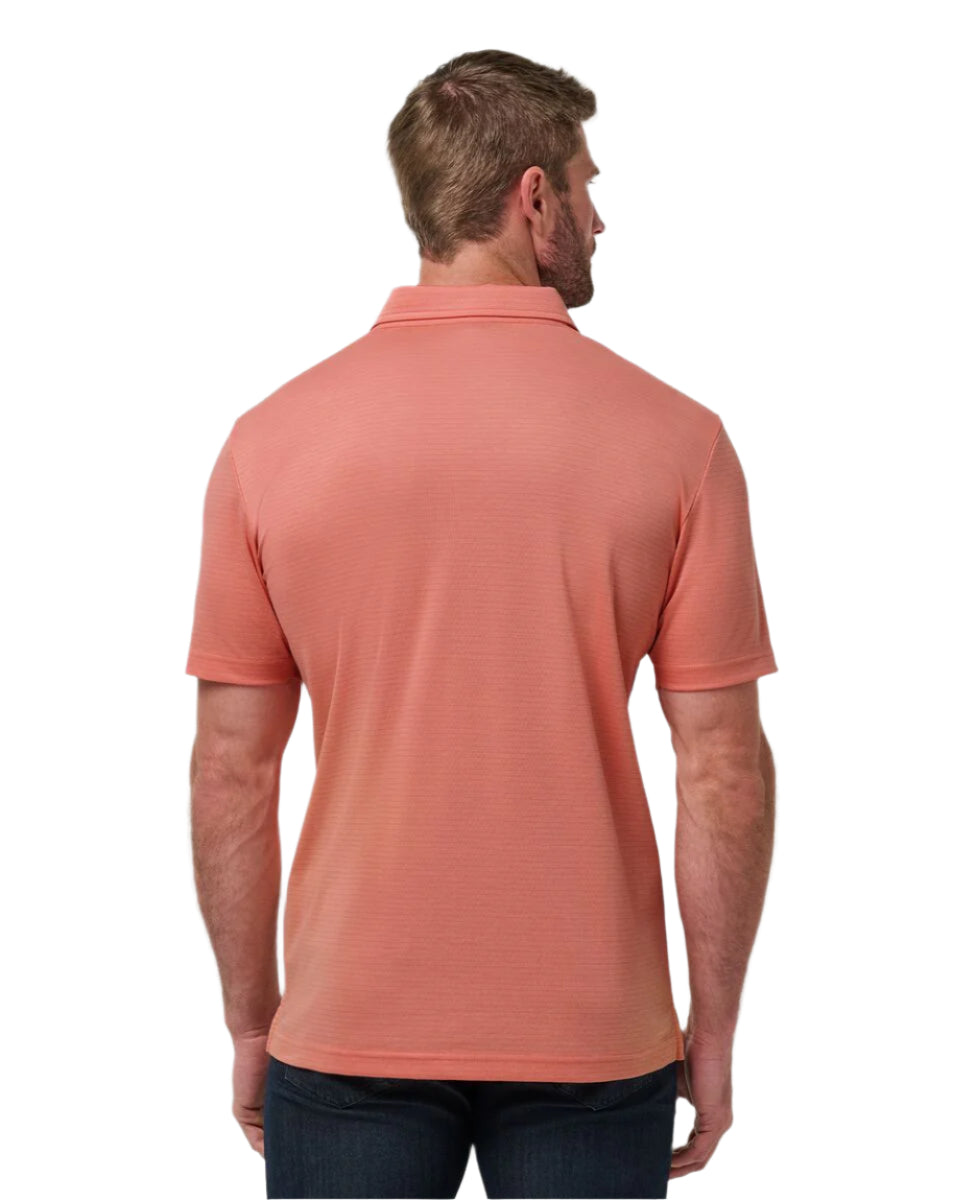 Man wearing a coral polo shirt on a white background
