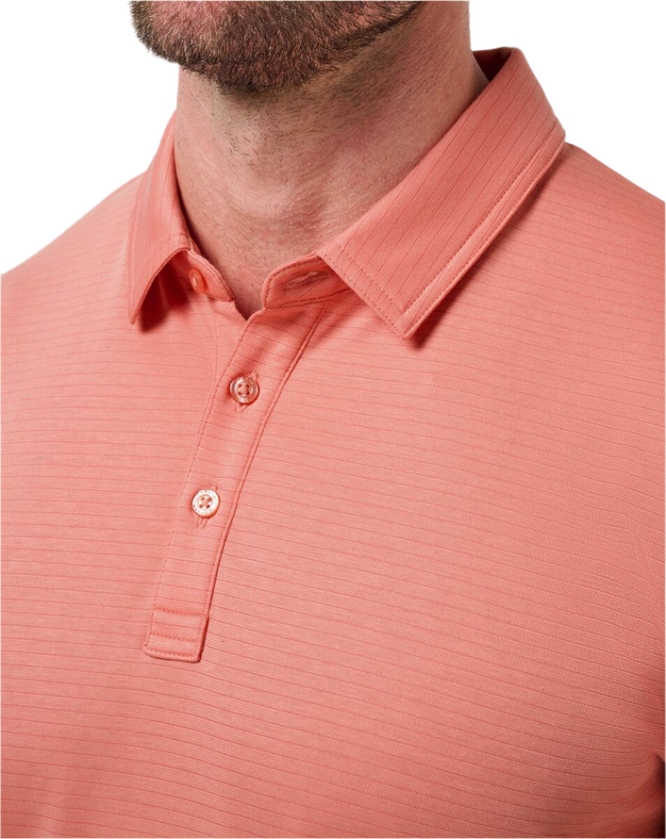 Close-up of a coral polo shirt on a white background