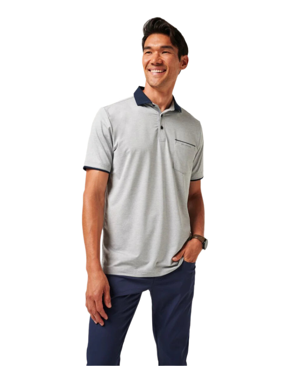 Man wearing a gray polo shirt with navy accents on a white background