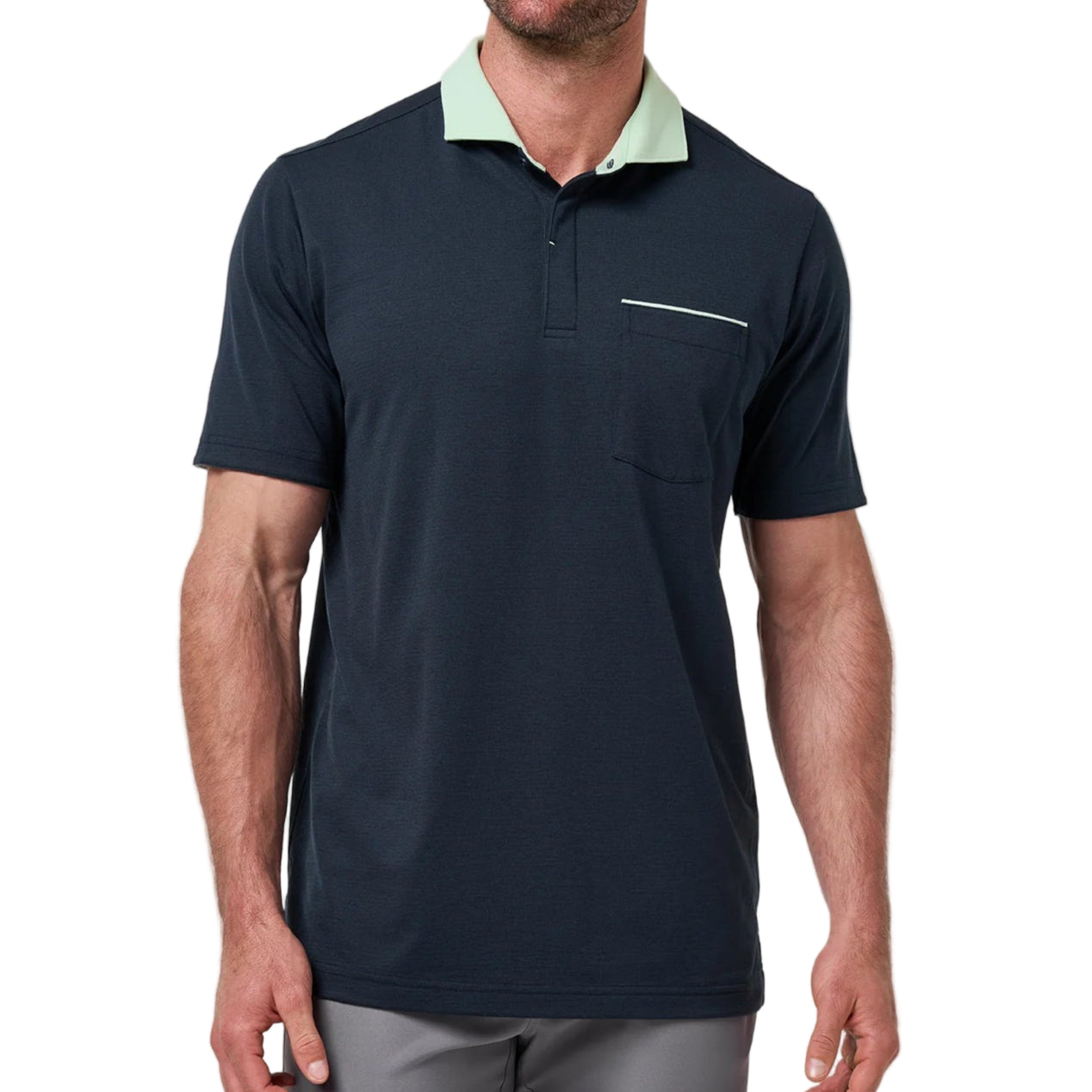 Man wearing a navy polo shirt with a light green collar against a plain background