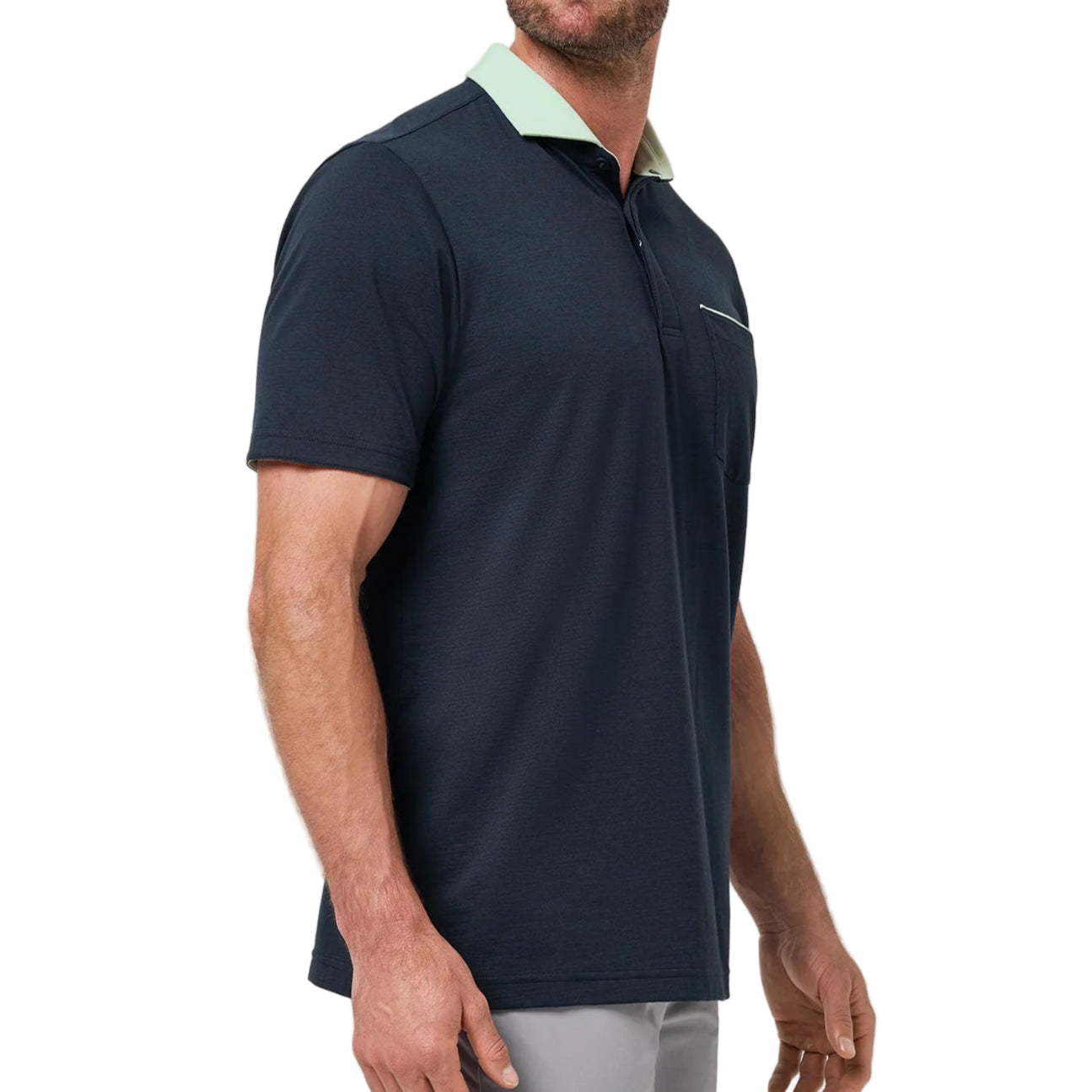 Man wearing a navy polo shirt with a light green collar against a white background