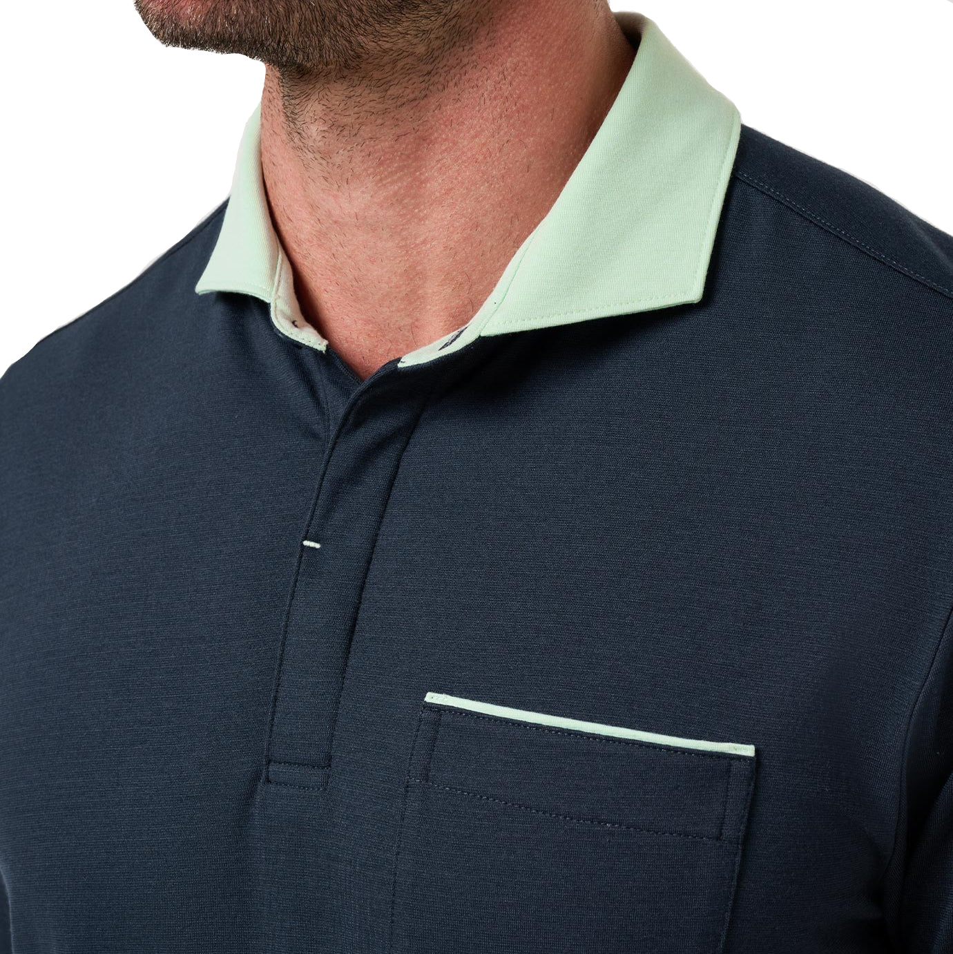 Navy polo shirt with light green collar on a plain background