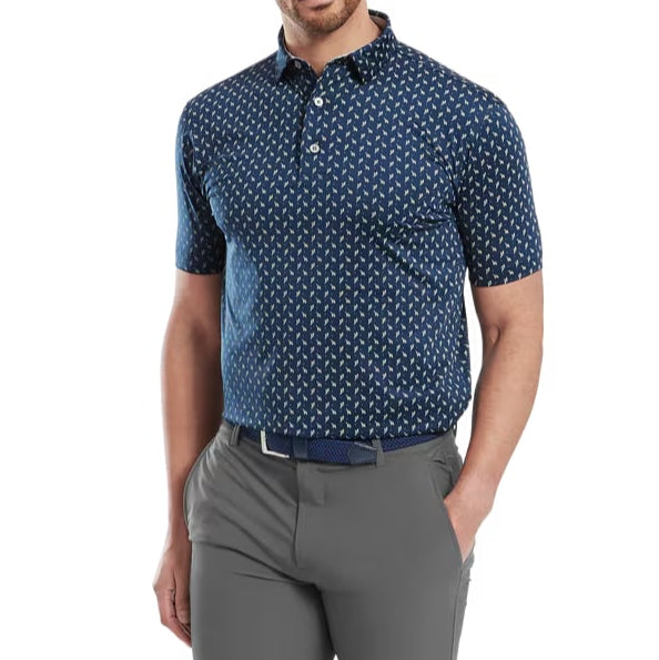 Man wearing a blue patterned shirt and gray pants on a white background