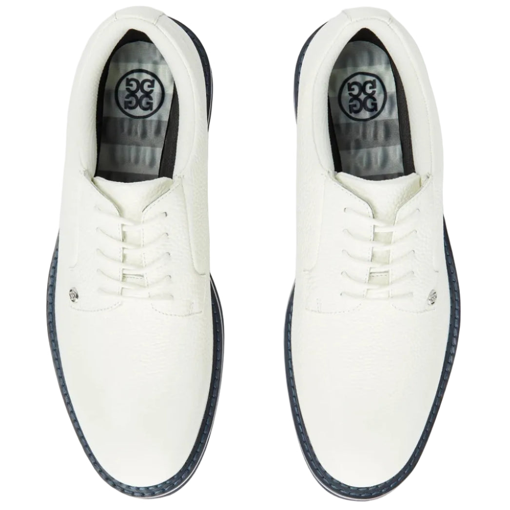 White golf shoes with black soles on a white background