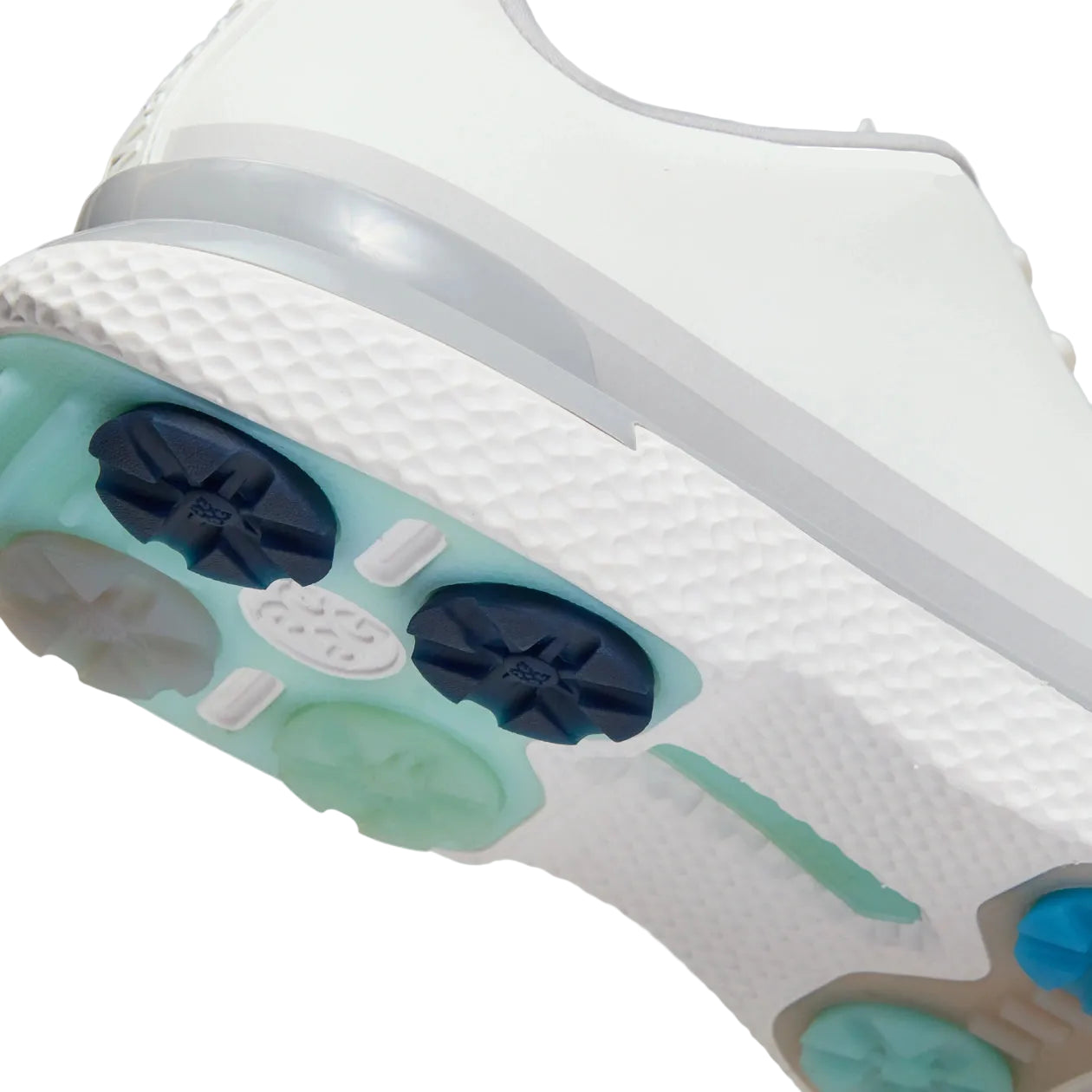 Close-up of a golf shoe sole with unique design on a light gray background