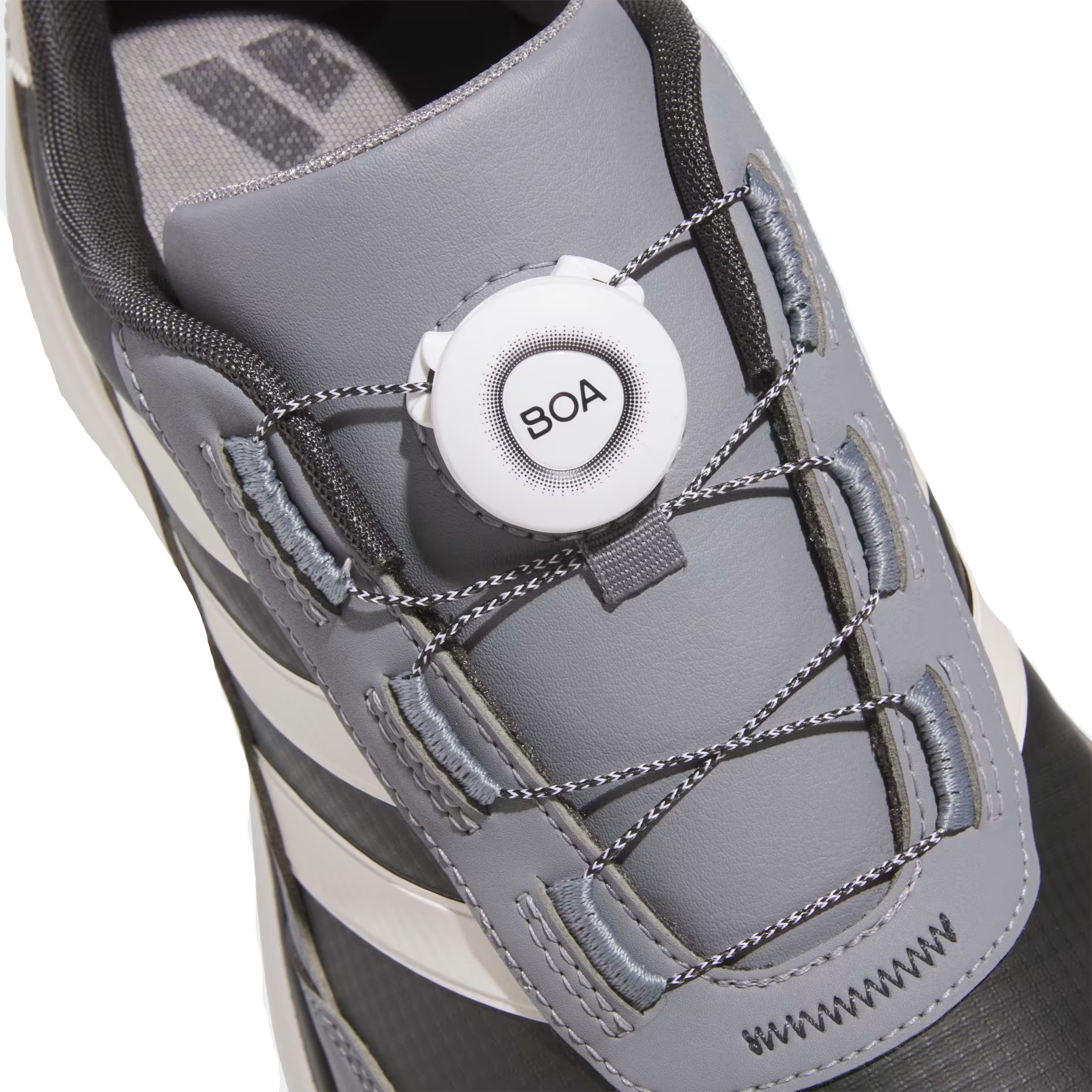 Gray athletic shoe with BOA system on a light gray background
