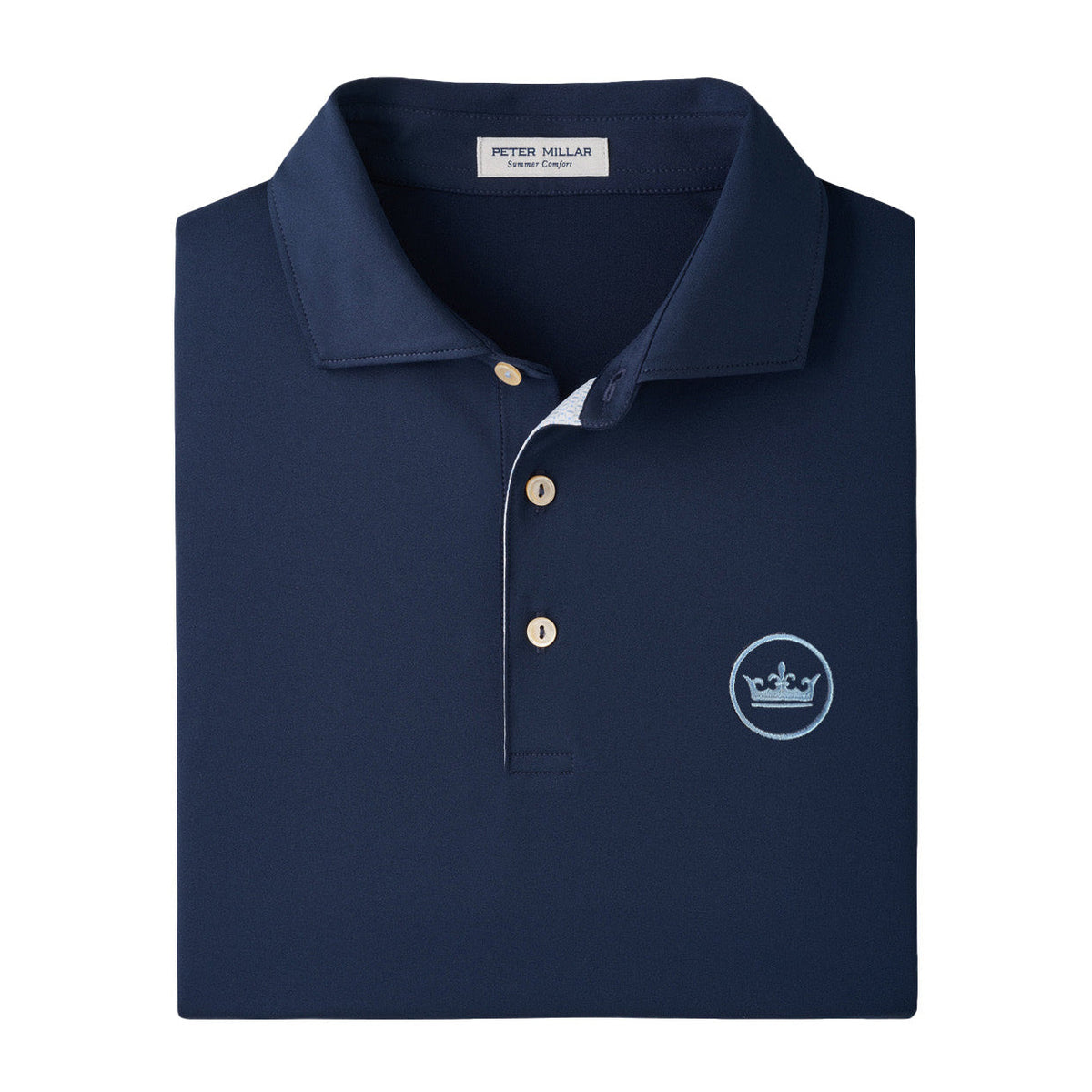 A folded navy blue polo shirt by Peter Millar, featuring a white embroidered crown logo on the left chest and a three-button placket.