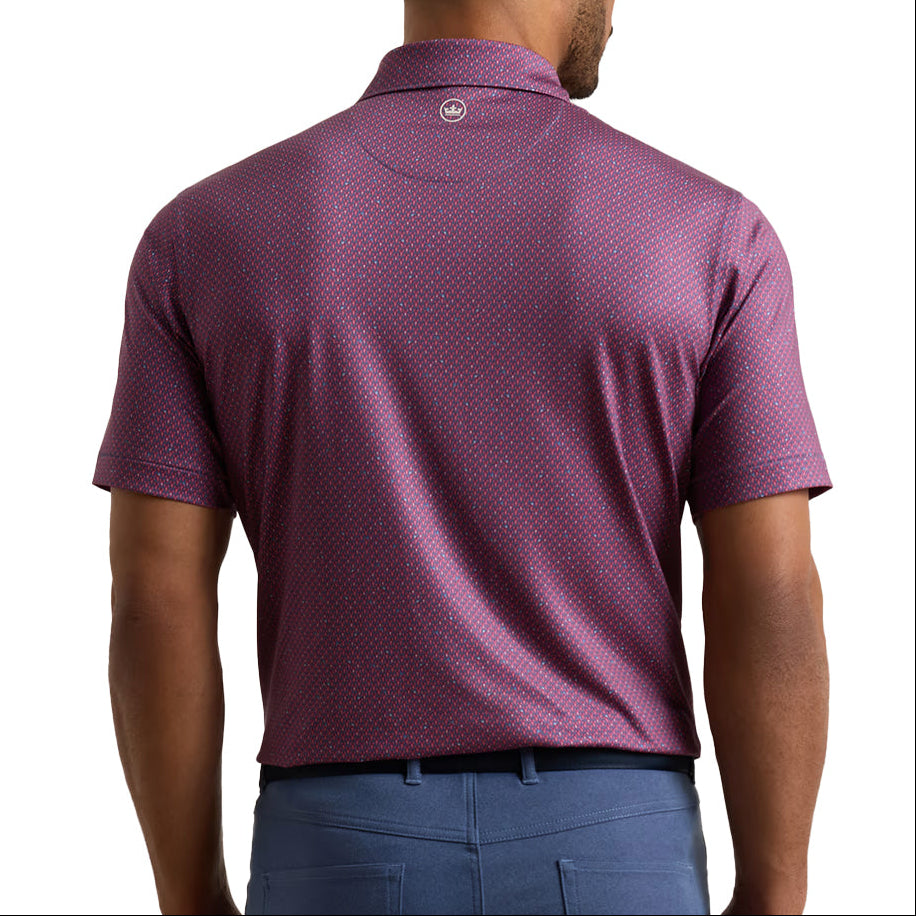 A man viewed from the back wearing a short-sleeve polo shirt in a textured plum-purple color with a subtle geometric pattern, paired with blue trousers, against a plain white background.