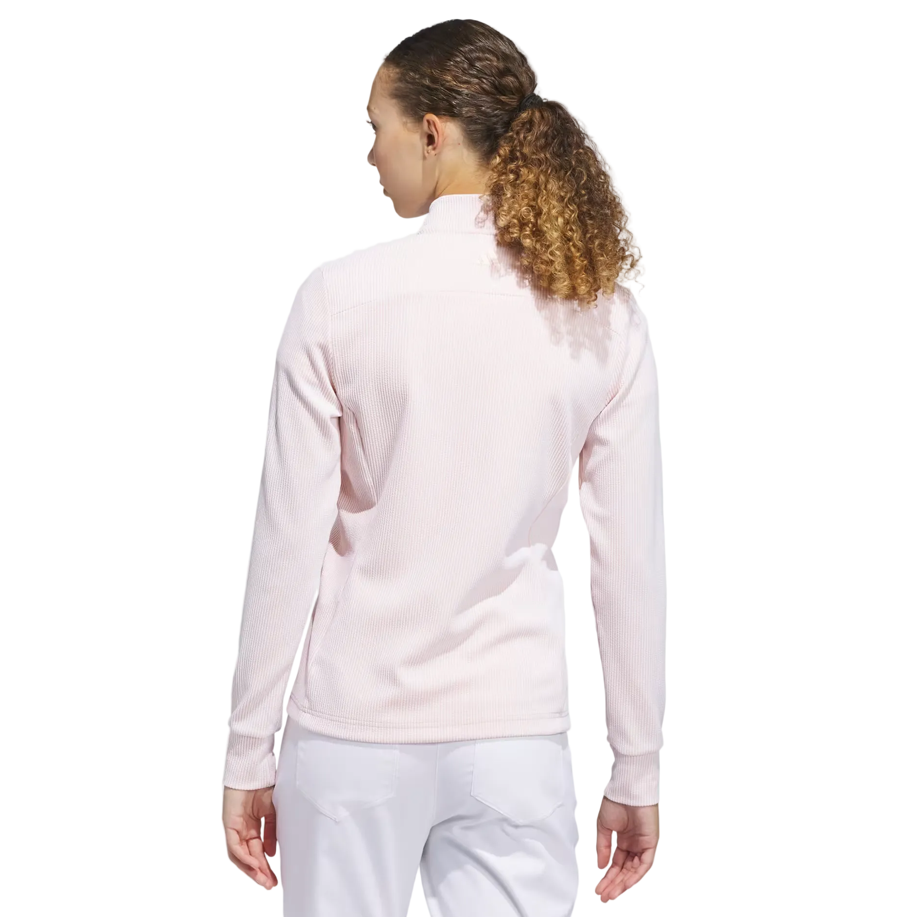 Person wearing a light pink long-sleeve top on a white background