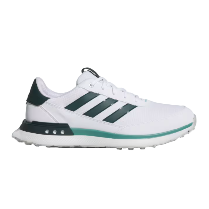 White Adidas sneaker with green accents on a light gray background
