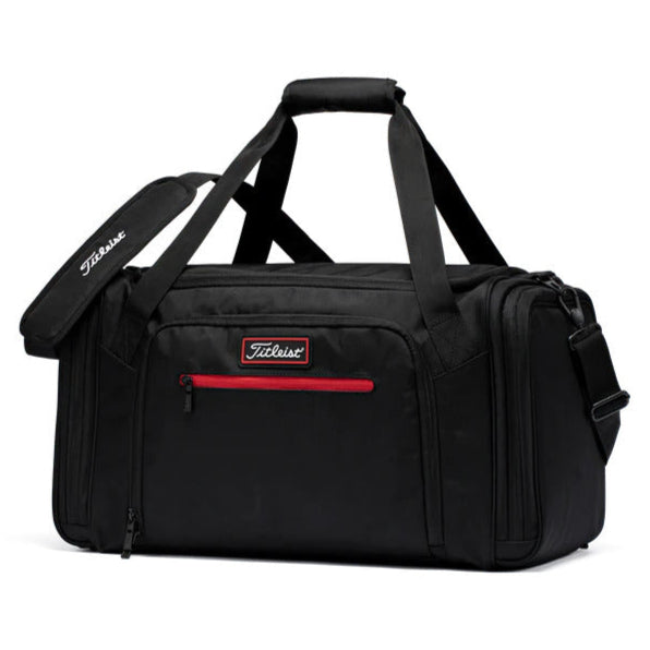 Black duffel bag with red zipper and titleist logo on a white background