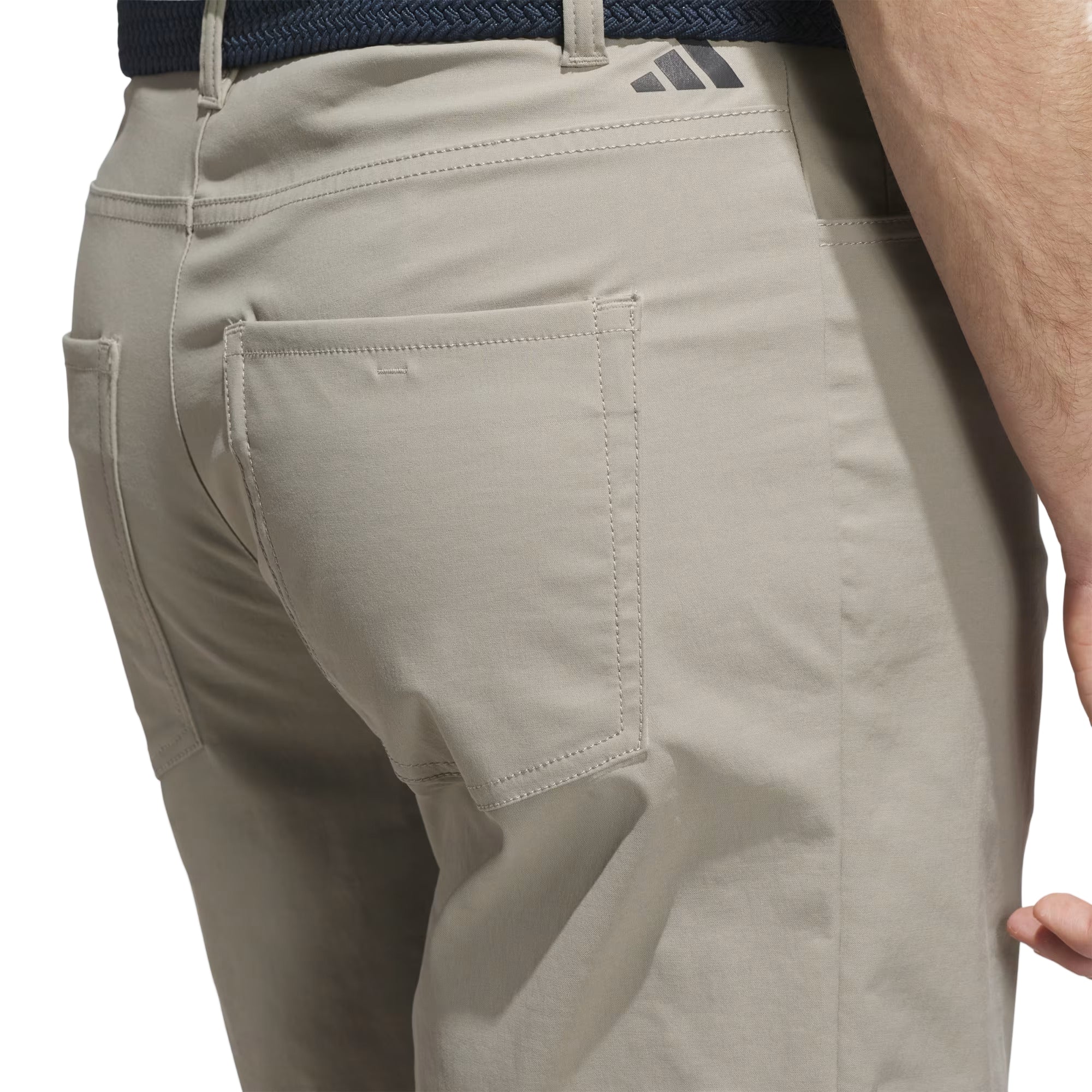 Beige pants with a visible brand logo on a light gray background