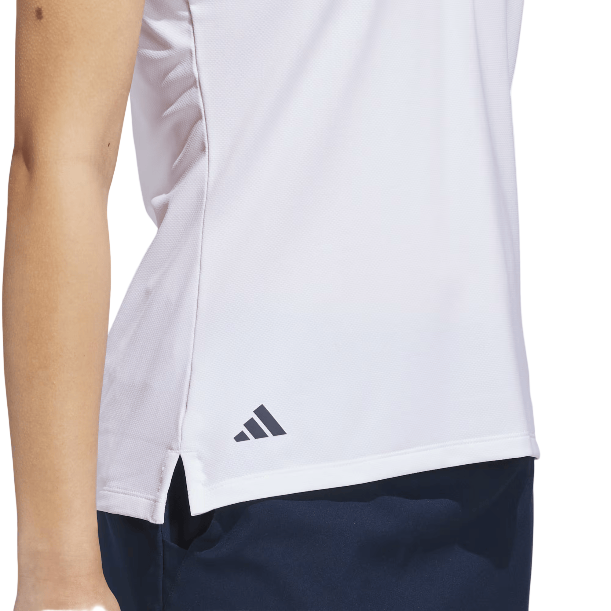 White athletic shirt with Adidas logo on a person wearing navy shorts against a light green background