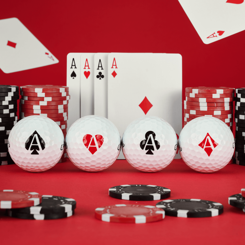 Four golf balls with playing card symbols on a red background with poker chips and cards.