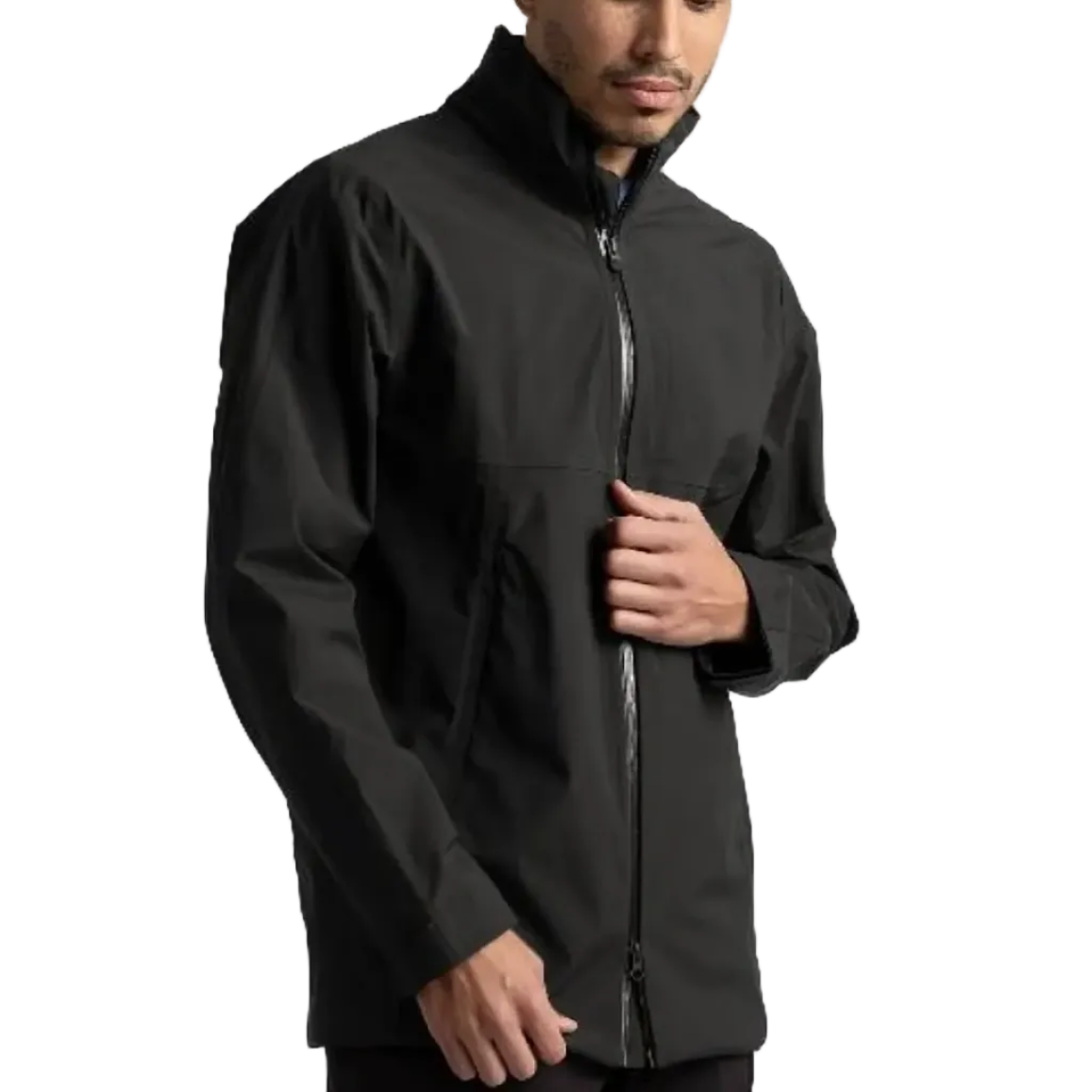 A man wearing a black waterproof zip-up golf jacket, standing against a plain light gray studio background.