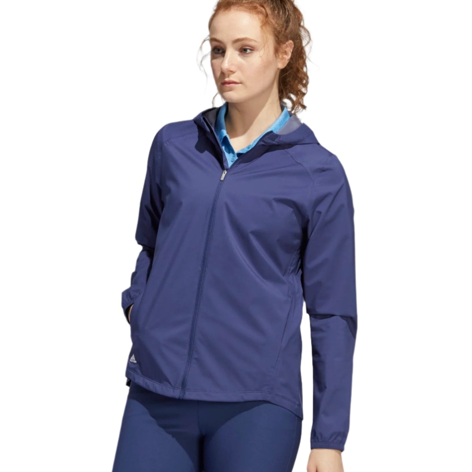 Woman wearing a blue jacket and leggings on a white background